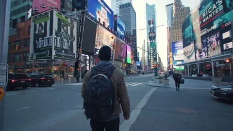 Man in mask looking up at Times Square NYC street Stock Footage 151767775