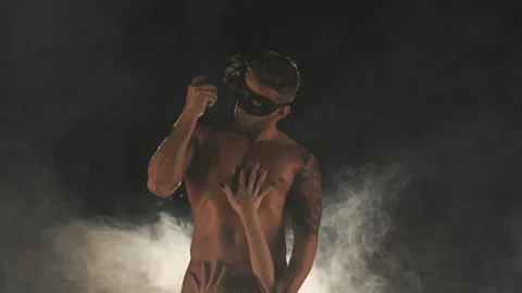 Man in a mask presses a grenade on his body Stock Footage 147996802
