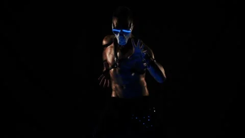 Man in a mask of a skull and glasses dance on black background Stock Footage