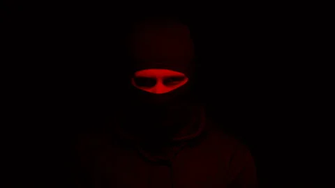 Man in mask standing under blinking red light, suicide bomber, terrorism Stock Footage 108755374