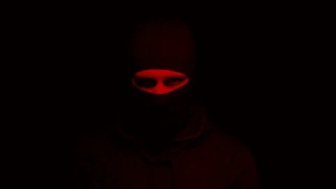Man in mask standing under blinking red light, suicide bomber, terrorism Stock Footage 108758369