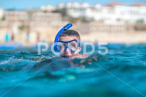 The man with mask swim in the ocean Stock Photos