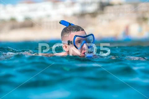 The man with mask swim in the ocean Stock Photos
