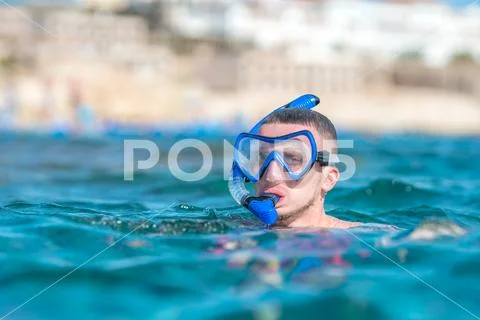 The man with mask swim in the sea Stock Photos