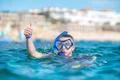 The man with mask thumb up in the ocean Photo