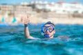 The man with mask thumb up in the ocean Photo