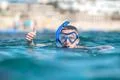 The man with mask thumb up in the sea Photo