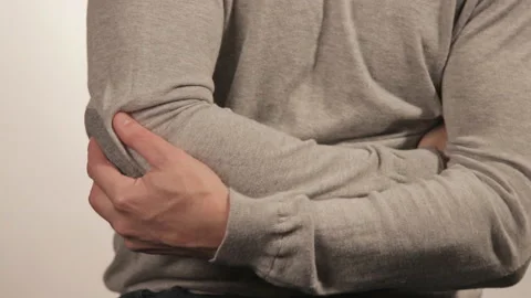The man massaging the elbow due to acute pain on a white background 動画素材 99574760