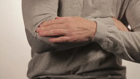 The man massaging the elbow due to acute pain on a white background 動画素材 99575518