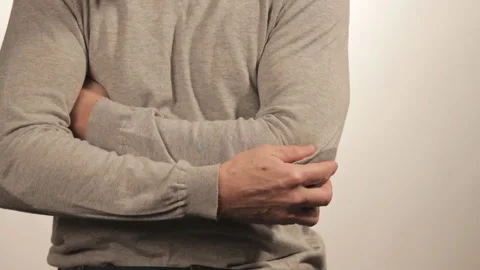 The man massaging the elbow due to acute pain on a white background 動画素材 99576331