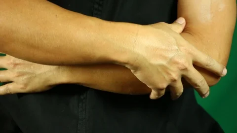 Man massaging his arms, in studio Stock Footage 98622787