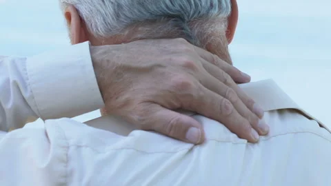 Man massaging his numb neck, problems with spine, poor sleeping conditions Stock Footage 99383012