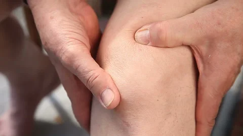 Man massaging a sore knee closeup Stock-Footage 64861928