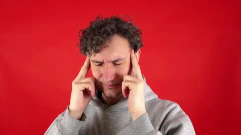 Man massaging temples and bridge of nose, suffering from burnout work. Видео 304750293