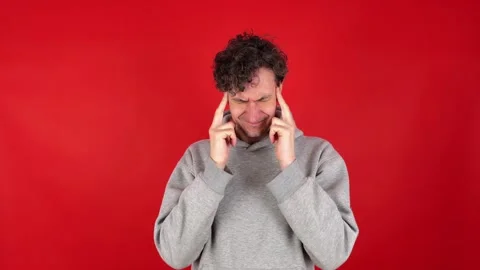 Man massaging temples and bridge of nose, suffering from burnout work. Stockbeeldmateriaal 304750372