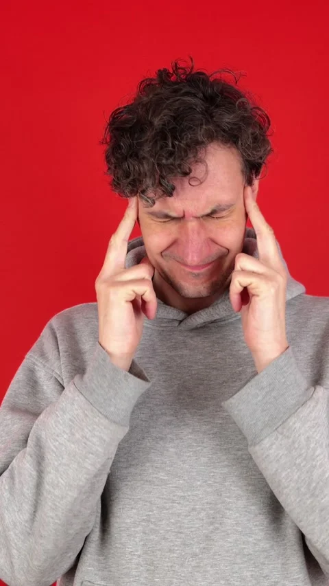 Man massaging temples and bridge of nose, suffering from burnout work 動画素材 304761936