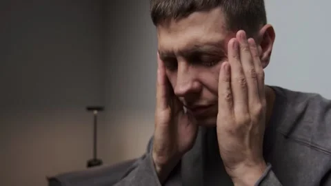 Man massaging temples severe headache stress relief close up minimal gray Video stock 315664593