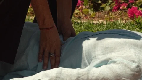 Man massagiste doing back massage in thai style to woman outdoor. Thai Stock Footage 90485189