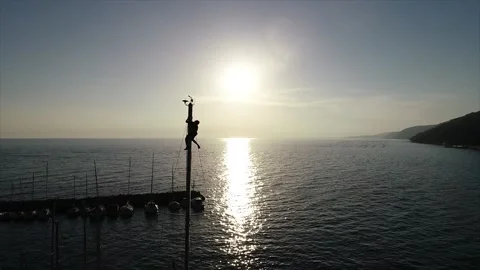 Man on mast sailboat Stock Footage 131175206