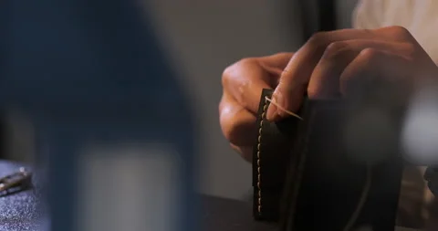 Man Master Make Genuine Leather Wallet for Private Order. Manufacture of Leather Stock Footage 148360501