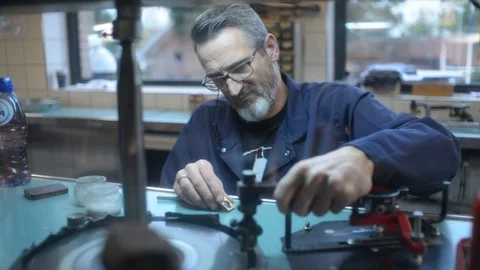A Man Master makes a Diamond cut, Jewelry on a Factory of Amsterdam Stock Footage 119062045