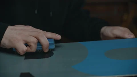 The man is a master of preparing a snowboard for the winter season Stock Footage 209897037