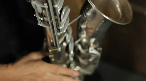 Man masterfully plays the saxophone in the studio Stock Footage 43098648