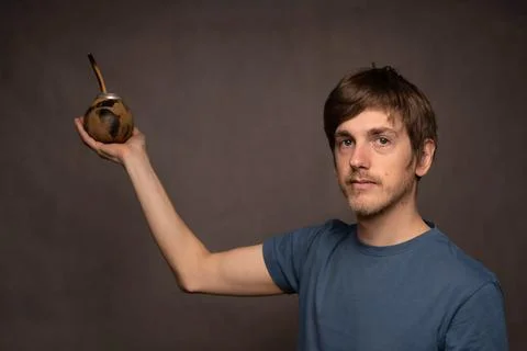 Man with mate cup on grey background Stock Photos