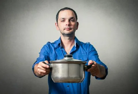 Man with the meal in pan Stock Photos