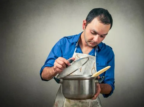 Man with the meal in pan Stock Photos