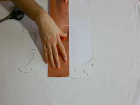 The man measures off and cuts a piece of copper foil. Top view of male hands, sh Video stock 84662002