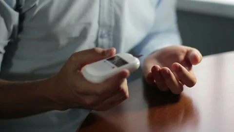 A man measures blood sugar with a glucometer Stock Footage 115487826