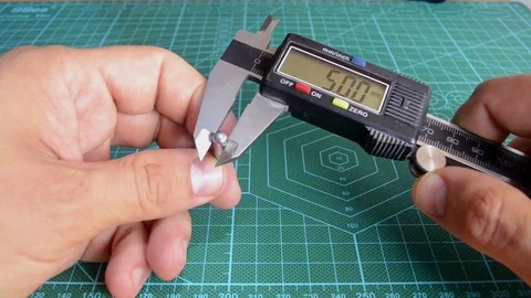 A man measures the diameter of a pin Stock Footage 115204015