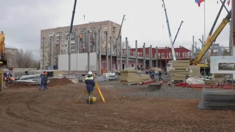 A man measures the distance on a building construction site with a laser Stock Footage 132201375