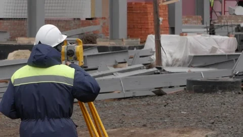 A man measures the distance on a building construction site with a laser Stock Footage 132201427
