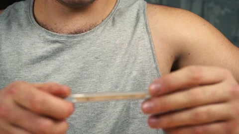 A man measures his temperature Stock Footage 144436666