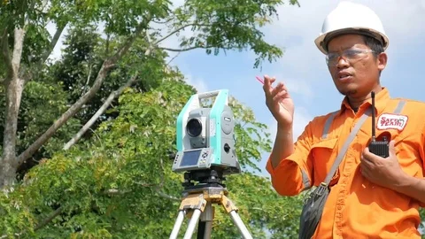 A man measures land topography using electronic theodolite Stockbeeldmateriaal 124270753