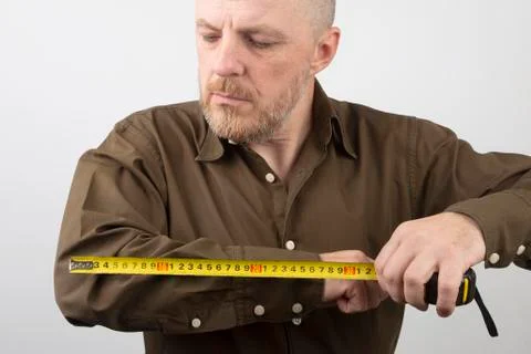 Man measures the length of his elbow centimeter Stock Photos