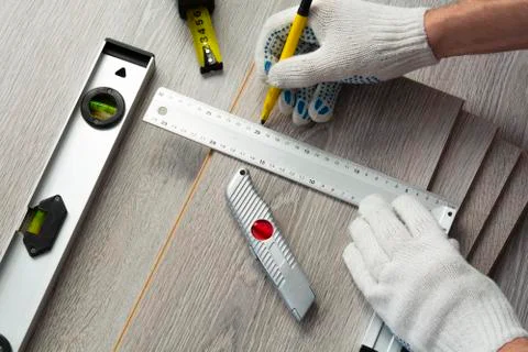 Man measures the new laminate Photos