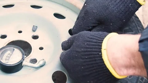 Man measures the pressure in the wheel Video stock 108112292