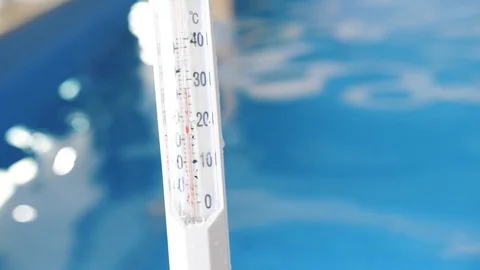 Man measures the temperature in the pool Stock Footage 127646208