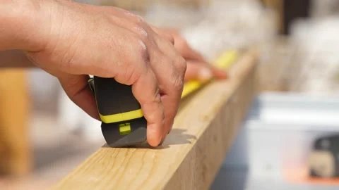 Man measures wooden structure with measuring tape Stock Footage 308019020