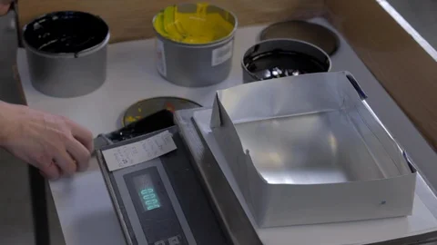 Man measures yellow paint using scales 스톡 동영상 109556543