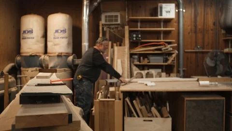 Man measuring board on workbench in workshop Stock Footage 102044945