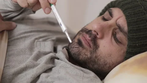 Man measuring fever with thermometer under his arm Stock Footage 163034541