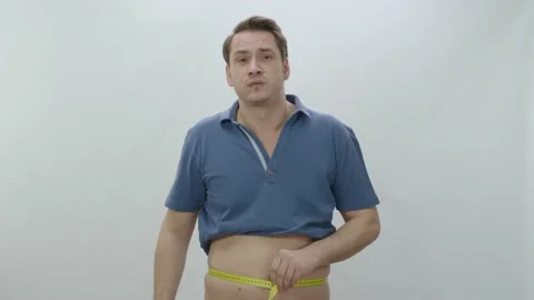 Man measuring hips and belly with tape measure. Stock Footage 196478209
