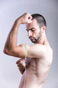 Man measuring his biceps size Stock Photos