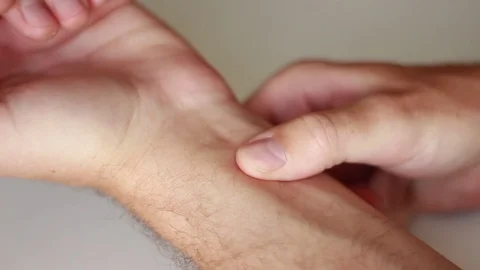 Man measuring his pulse Stock Footage 77184899