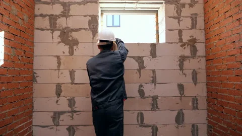 Man measuring length of window in building Stock Footage 97974447