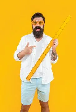 Man with measuring ruler on background, pointing finger. photo of man with Stock Photos